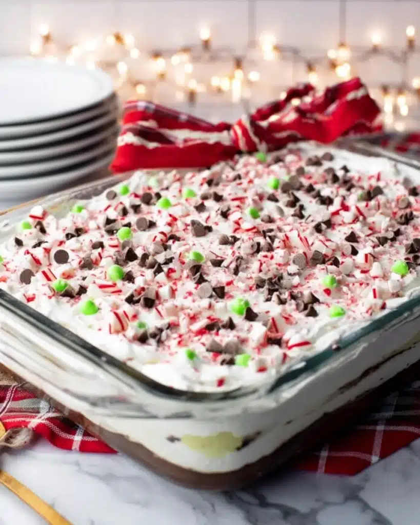 Christmas Lasagna Dessert 3 Festive Christmas lasagna dessert topped with whipped cream and crushed peppermint