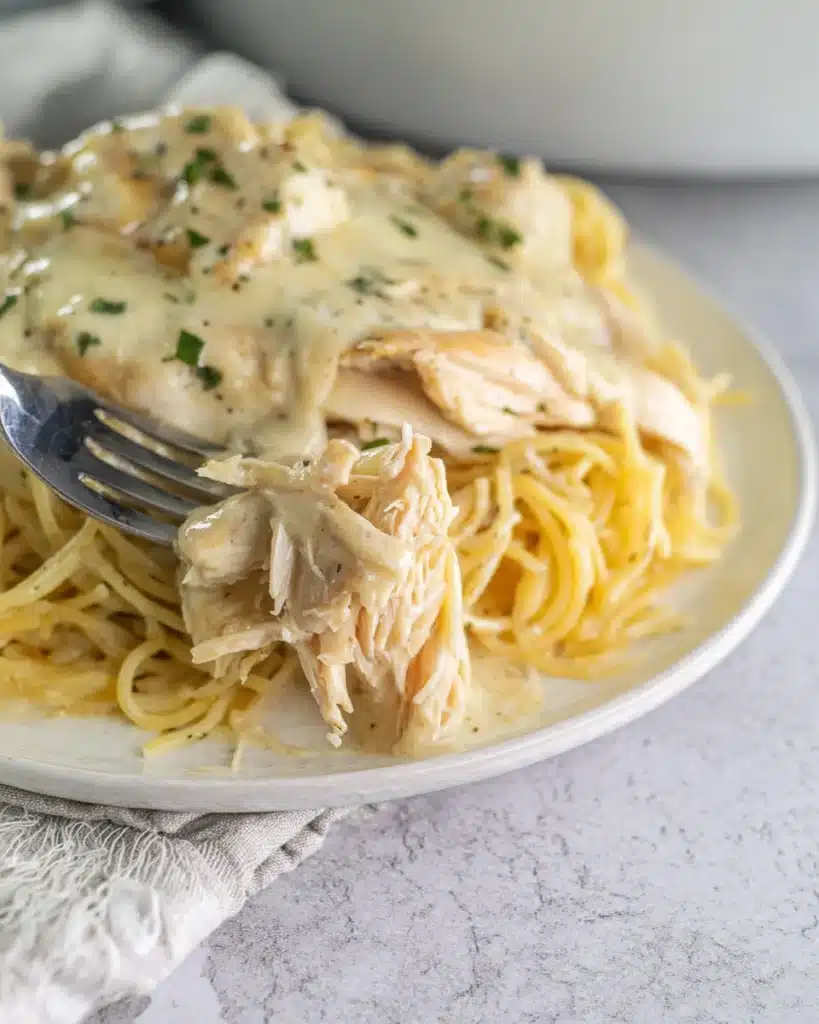 Crockpot Angel Chicken (Creamy Slow Cooker Favorite) 2 Creamy Crockpot Angel Chicken with pasta and sauce on a plate