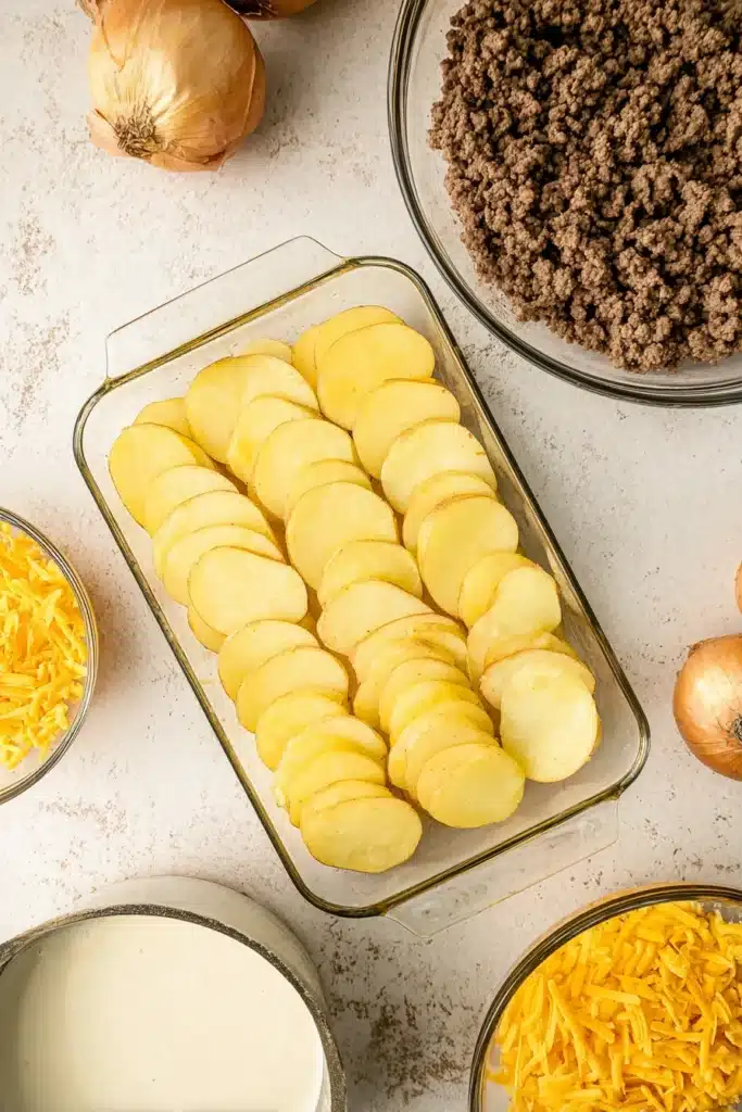 Hobo Casserole 2 Layered potatoes and ground beef ingredients for Hobo Casserole preparation