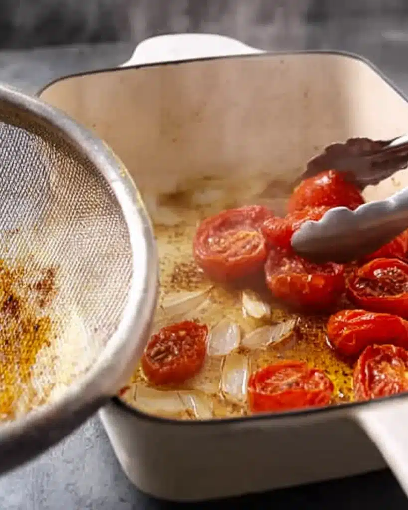 Tomato Basil Soup (Roasted Fresh Tomato Recipe) 3 Adding roasted tomatoes and onions to pot with garlic for soup