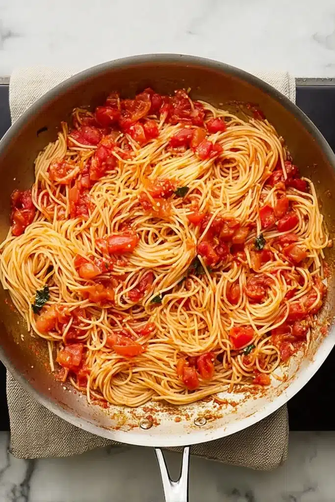 Tomato and Garlic Pasta 4 Angel hair pasta tossed in tomato and garlic sauce in a skillet