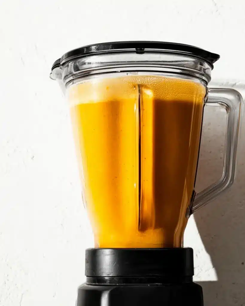 Blender filled with creamy roasted butternut squash soup