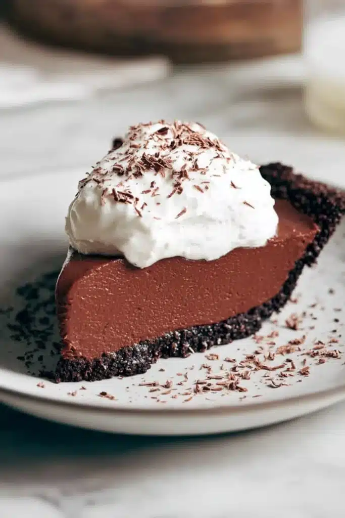 Life-Changing Chocolate Pie Recipe 1 Slice of chocolate pie with whipped cream on a plate