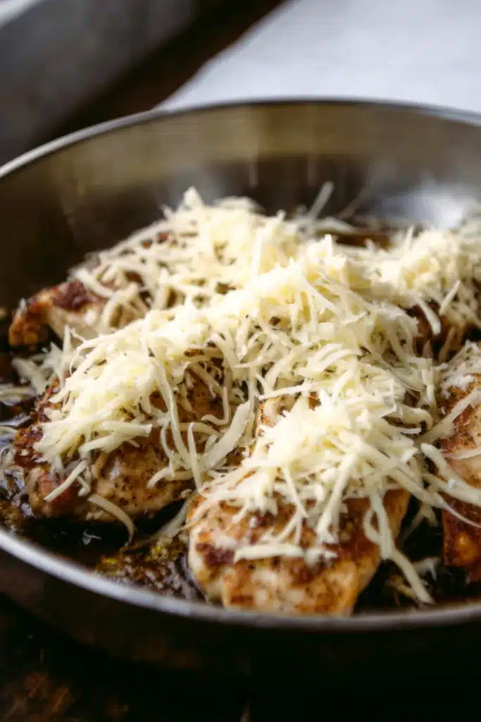 French Onion Chicken 4 Chicken topped with shredded cheese in skillet before broiling for French Onion Chicken