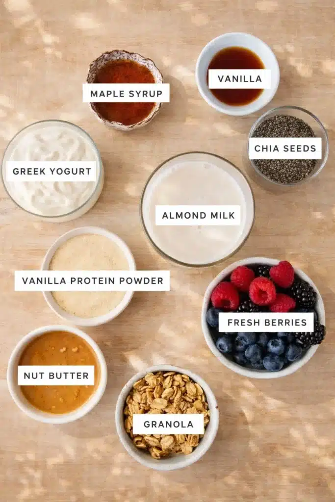 Protein Chia Pudding 2 Protein chia pudding ingredients including chia seeds, almond milk, berries, yogurt, and protein powder