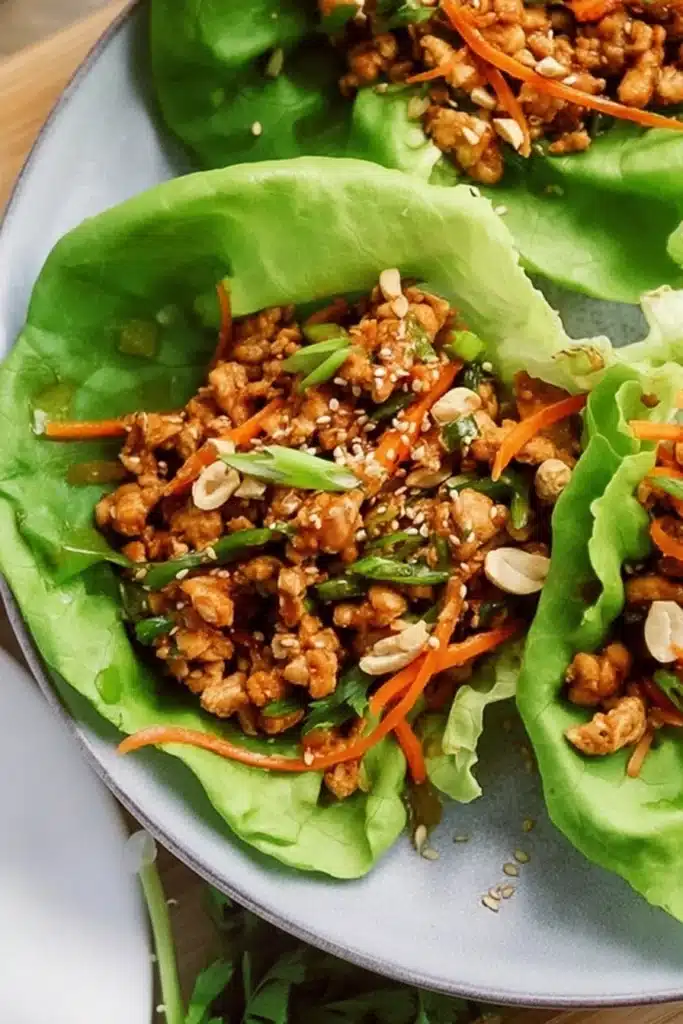 Thai Chicken Lettuce Wraps with carrots, cashews, and sesame seedsThai Chicken Lettuce Wraps with carrots, cashews, and sesame seeds