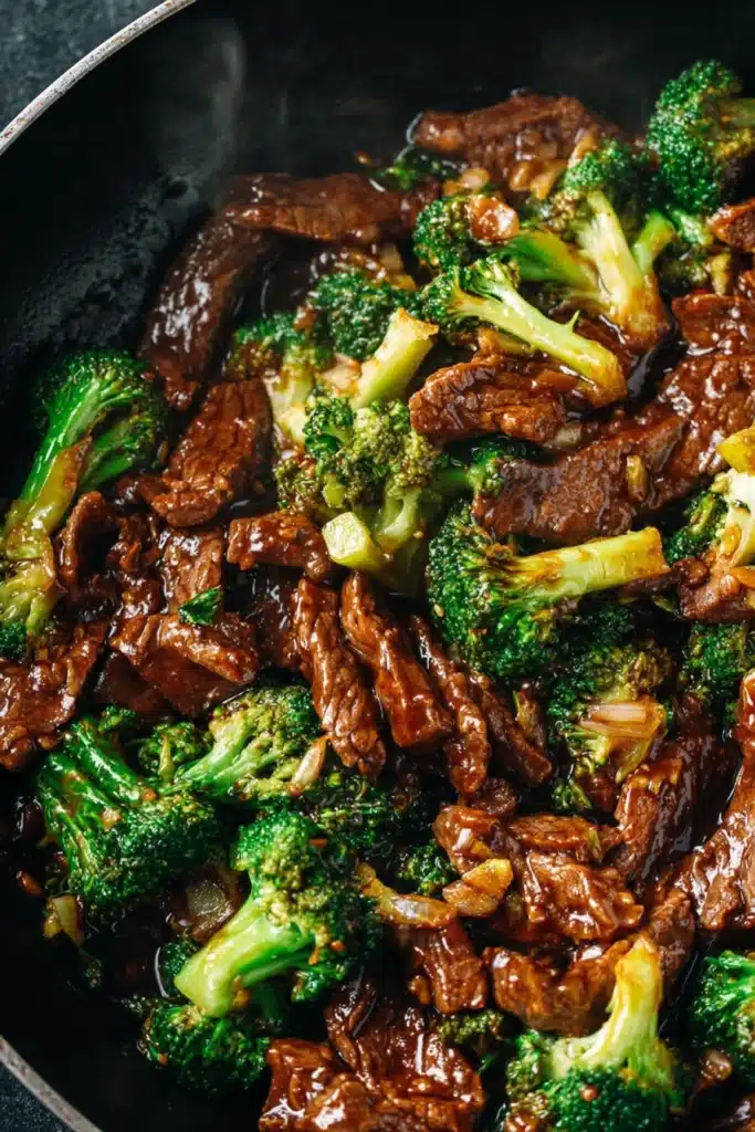 Chinese Beef and Broccoli Recipe That’s Better Than Takeout 2 Chinese beef and broccoli stir fry with glossy garlic soy sauce in dark bowl