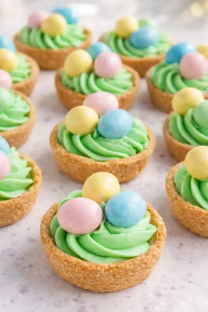 Easter Basket Sugar Cookie Cups 1 Easter basket sugar cookie cups with green frosting and pastel candy eggs