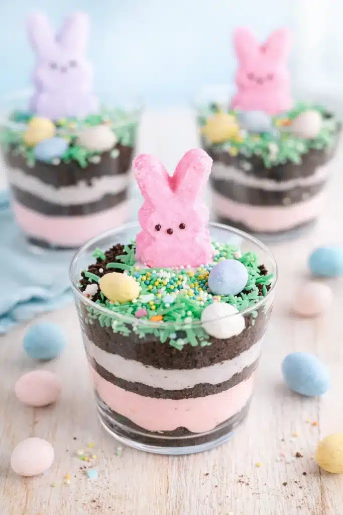 Easter Dirt Cups That Are Fun, Creamy, and Kid Approved 2 Easter Dirt Cups layered with pastel pudding, Oreo crumbs, and marshmallow bunny