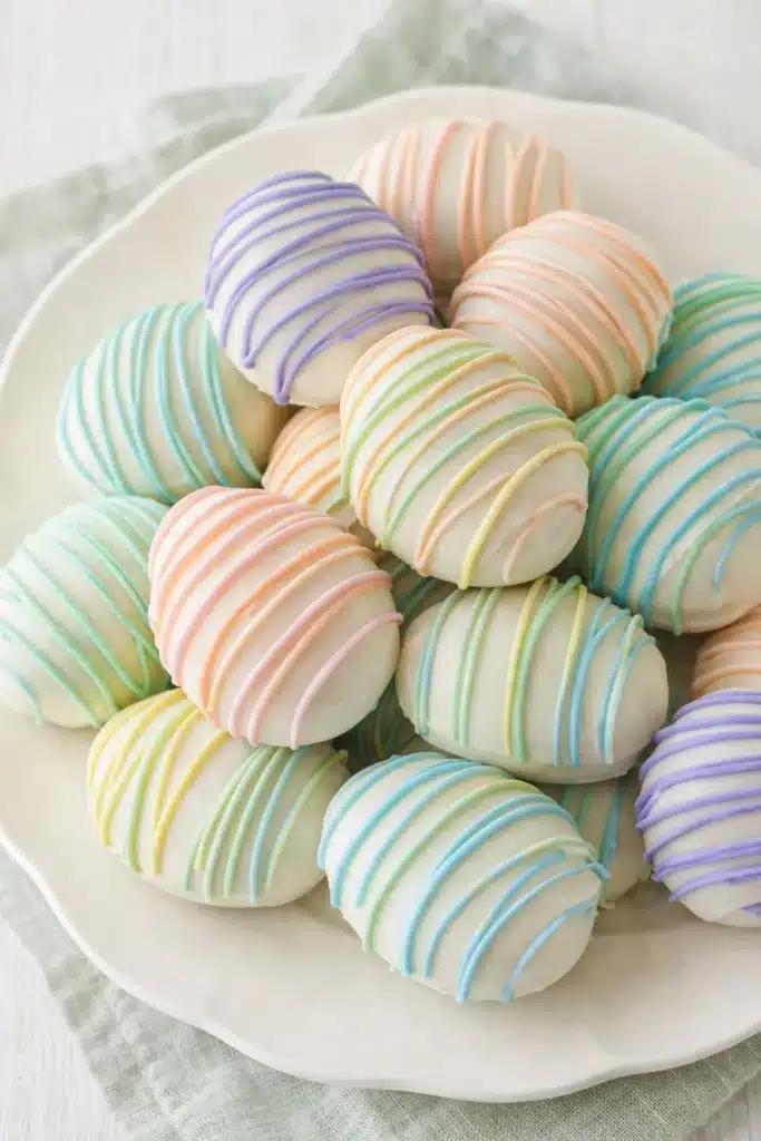 Easter Egg Oreo Cookie Balls That Are Easy and Adorable 1 Pastel Easter Egg Oreo Cookie Balls with colorful drizzle on white plate