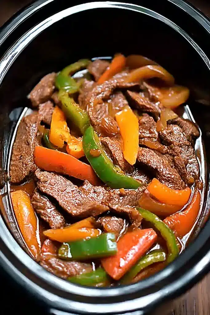 Easy Crockpot Pepper Steak 1 Easy Crockpot Pepper Steak with beef strips and colorful bell peppers in rich sauce