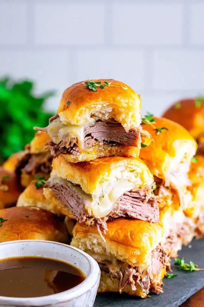 French Dip Sliders Easy, Cheesy, Crowd Pleasing Lunch 2 Bitten French Dip Sliders stacked with roast beef and melted Swiss cheese