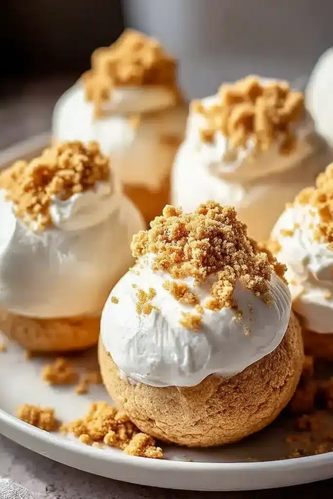 No-Bake Pumpkin Cheesecake Balls 1 Creamy no-bake pumpkin cheesecake balls with graham crumb topping on a plate