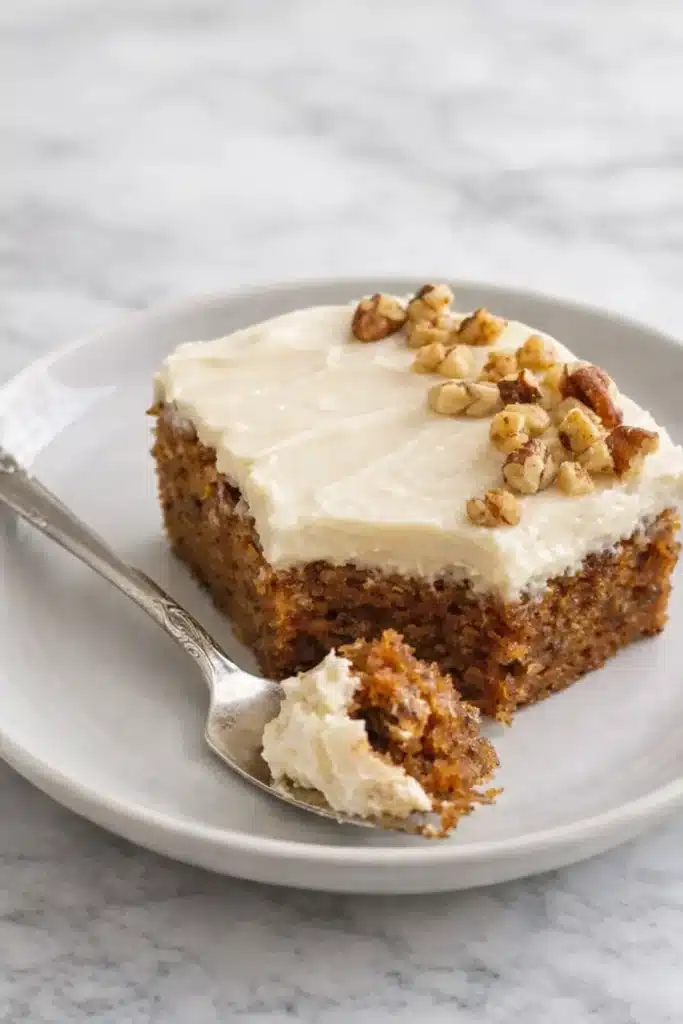 Carrot Cake With Cream Cheese Frosting slice on plate with fork