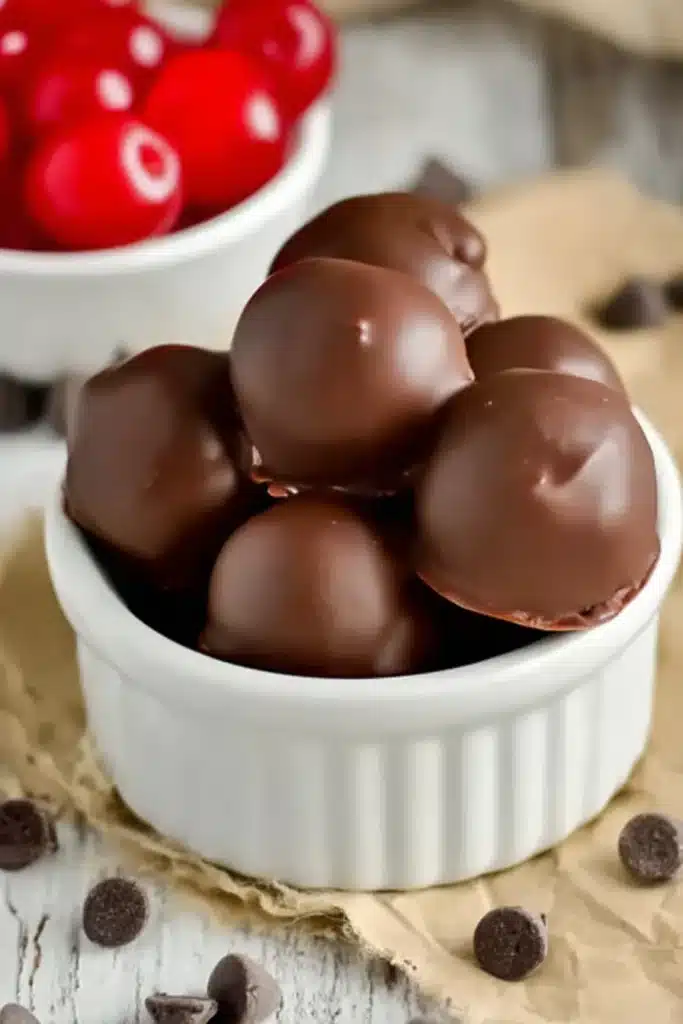 Cherry Brownie Bombs 2 Cherry Brownie Bombs in a ramekin with chocolate coating and cherries