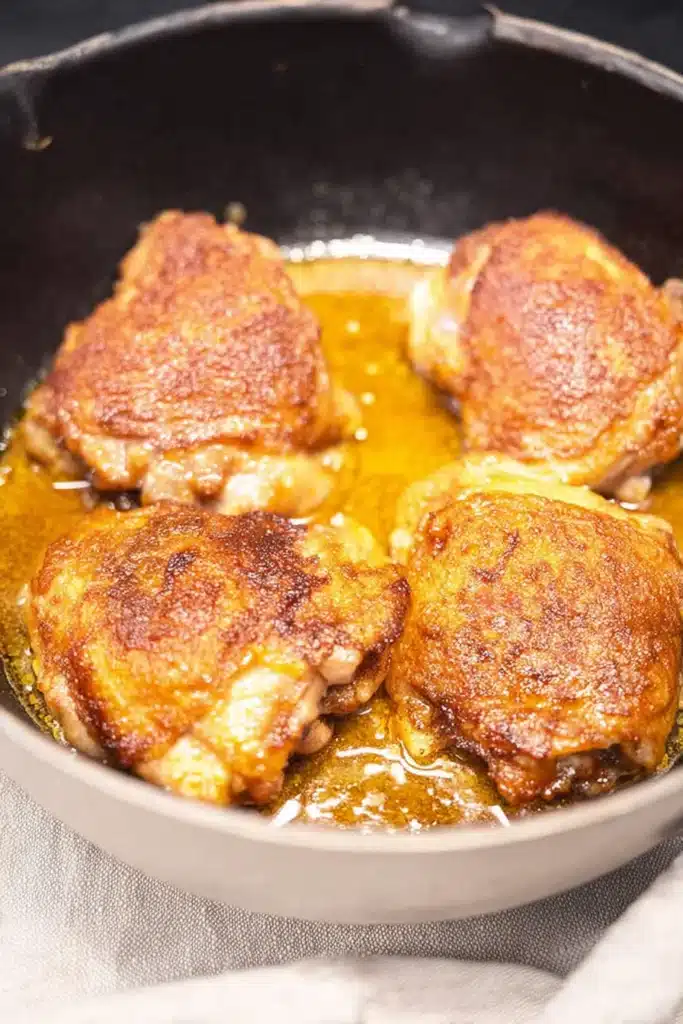 Chicken Paprikash chicken browning in pan with crispy golden sear