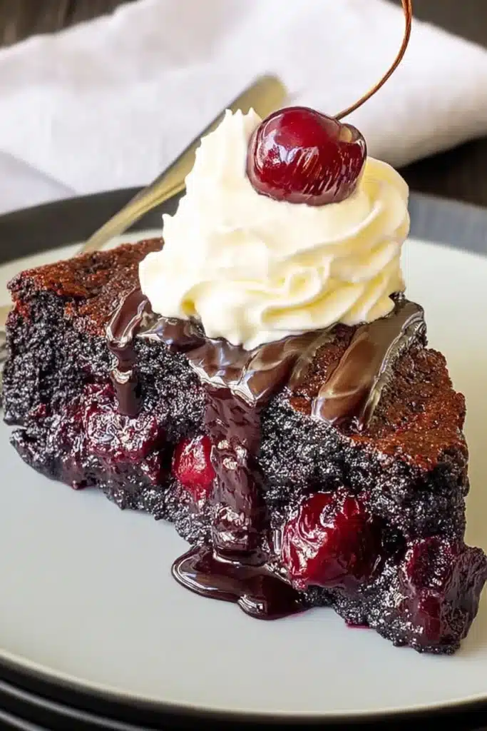 Chocolate Cherry Upside Down Cake 1 Slice of chocolate cherry upside down cake with whipped cream and chocolate drizzle