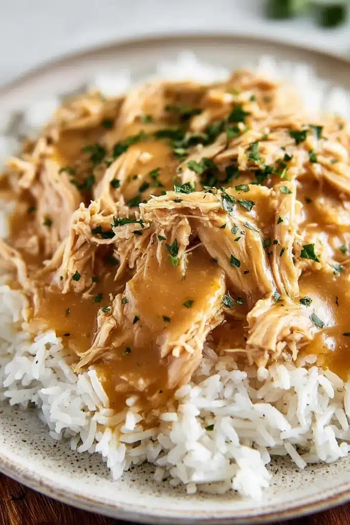 Crockpot Chicken and Gravy Easy Comfort Meal Recipe 2 Crockpot chicken and gravy served over rice with creamy sauce
