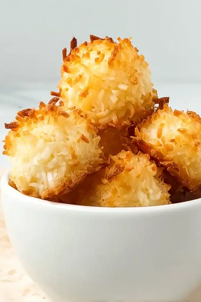 Keto coconut macaroons with crispy golden edges in a white bowl