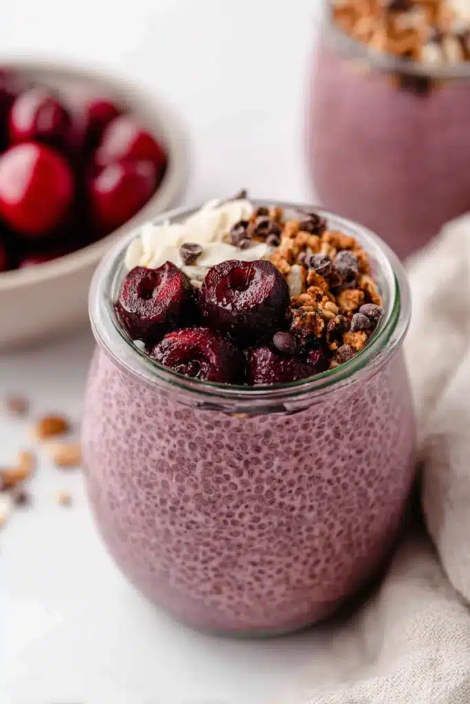 Cherry Chia Pudding Recipe You’ll Love 1 Cherry chia pudding topped with granola and cherries in a glass jar