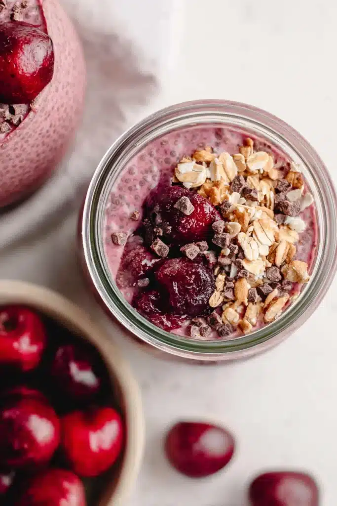 Cherry Chia Pudding Recipe You’ll Love 2 Cherry chia pudding with granola and cherries in a glass jar