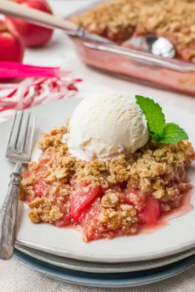 Easy rhubarb crisp with oat topping and vanilla ice cream on a plate