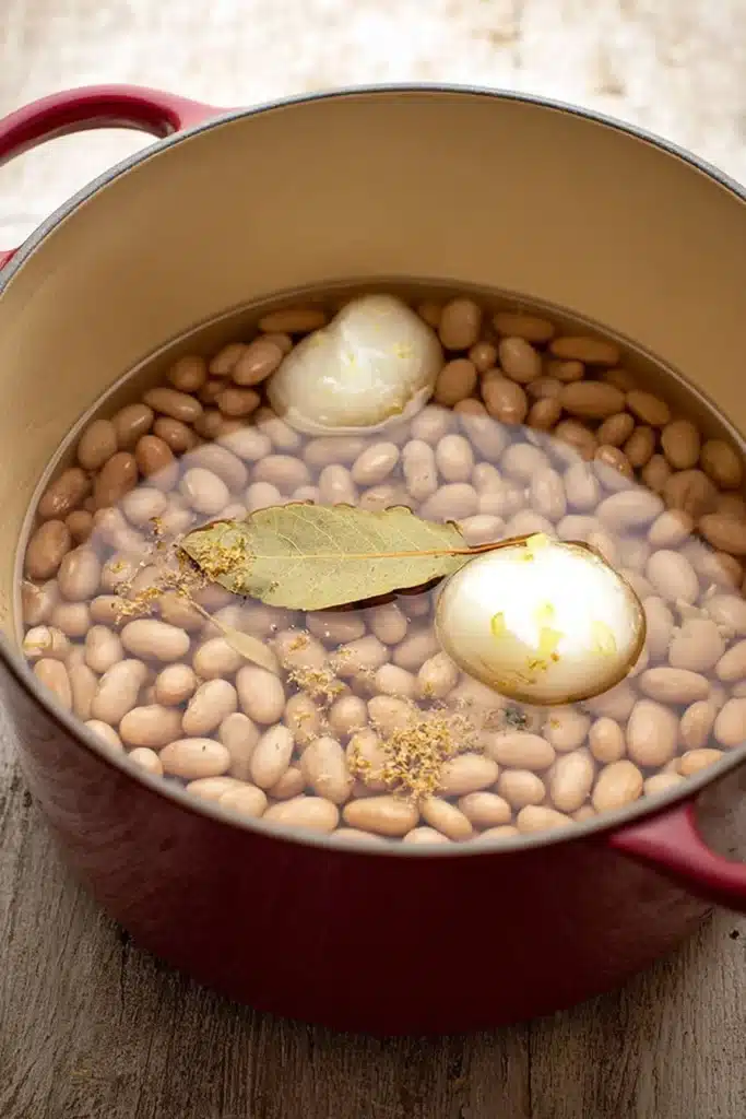 Refried Beans: Authentic, Creamy & Easy Homemade Recipe 2 Refried beans soaking pinto beans with onion garlic and bay leaf