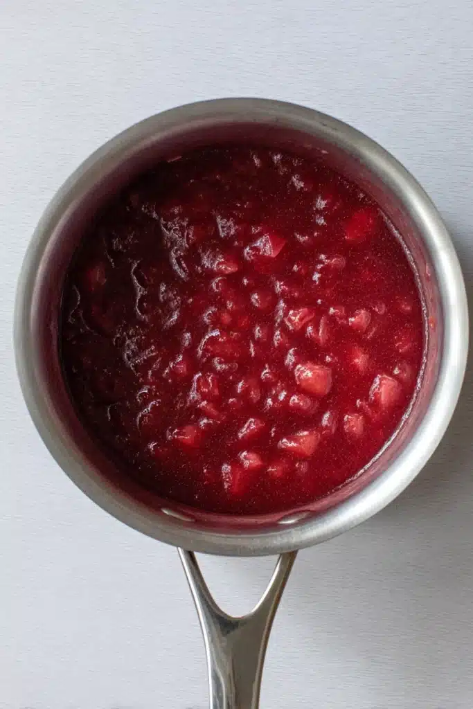 Rhubarb Ice Cream: A Creamy, Tangy Homemade Treat 2 Rhubarb ice cream jam mixture cooking in saucepan with glossy texture