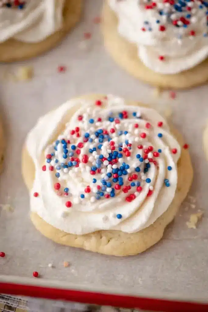 Crumbl Patriotic Birthday Cake Cookies Recipe for 4th of July 1 Crumbl Patriotic birthday cake Cookies with frosting and red white blue sprinkles