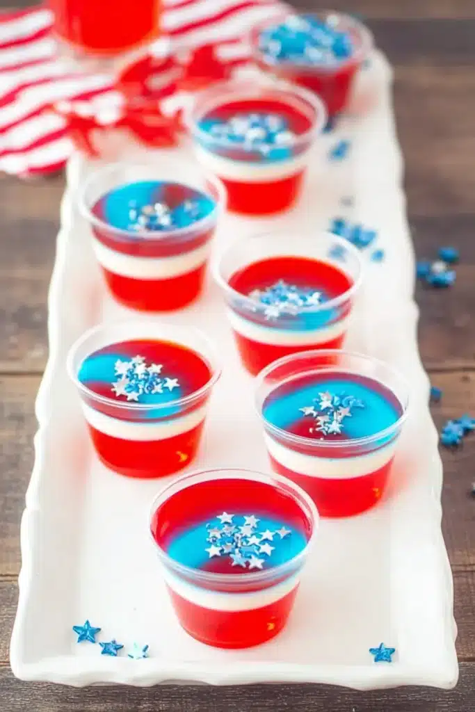 Red White & Blue Jello Shots 3 Close up of Red White & Blue Jello Shots with layered gelatin and sprinkles