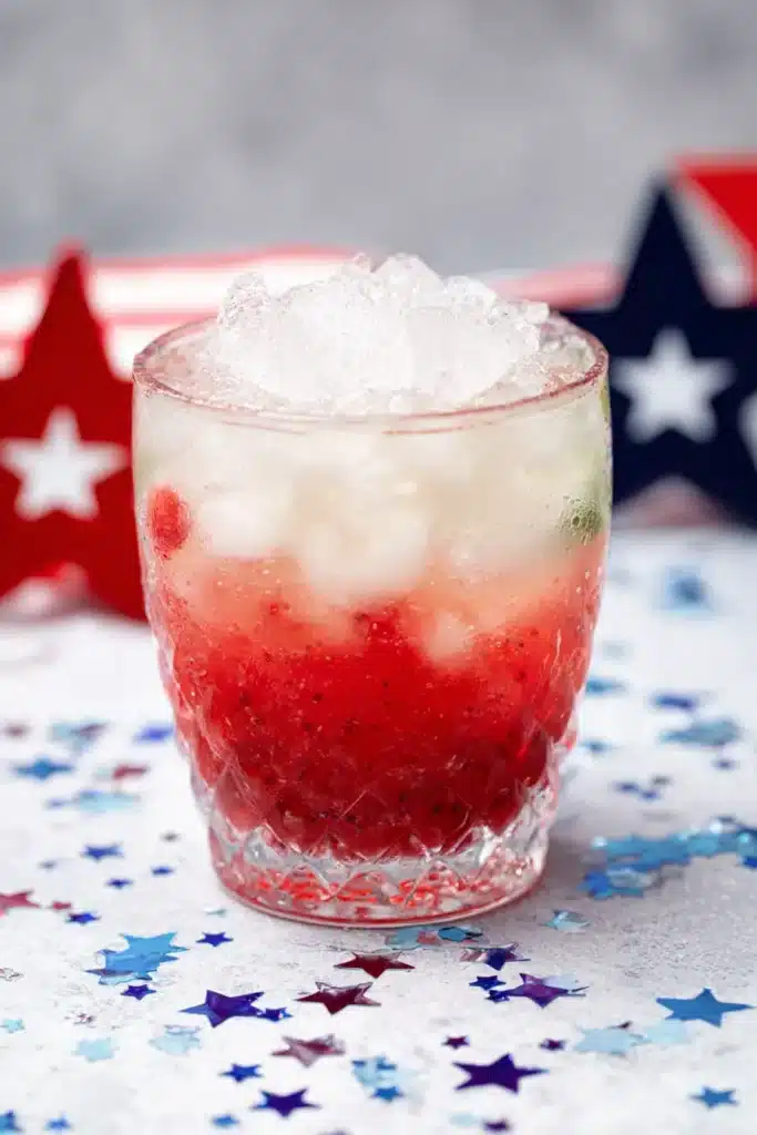 4th Of July Mojito 3 4th Of July Mojito with crushed ice and raspberry layer in festive cocktail glass