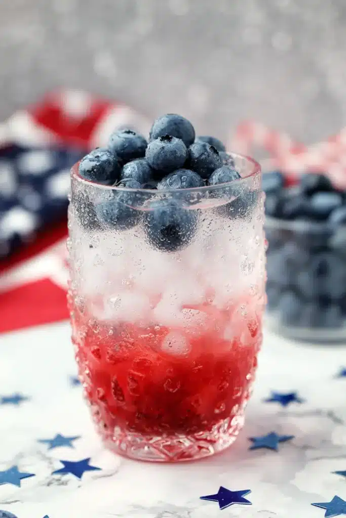 4th Of July Mojito 1 4th Of July Mojito with blueberries and raspberry layers in a festive cocktail glass