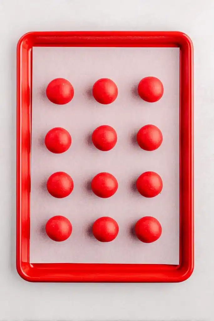 4th Of July Oreo Balls coated in red candy melts on a tray