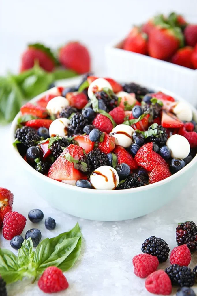 Berry Caprese Salad 1 Berry Caprese Salad with fresh berries, mozzarella pearls, basil, and balsamic glaze