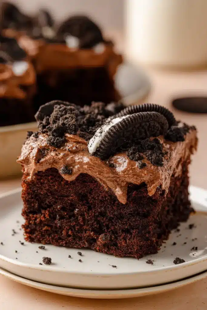 Oreo Dirt Cake Recipe 5 Oreo dirt cake slice with creamy chocolate topping and crushed Oreo cookies
