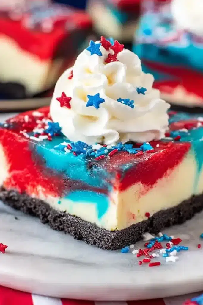 Red White and Blue Cheesecake Bars 1 Red White and Blue Cheesecake Bars with Oreo crust and whipped cream