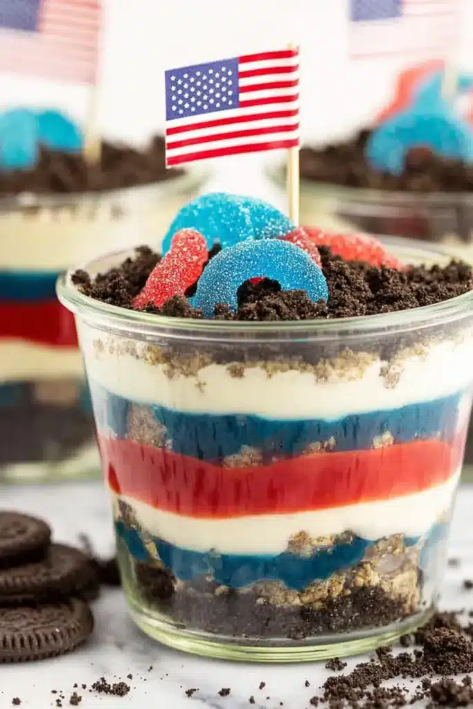 Red White and Blue Dirt Cups 1 Red White and Blue Dirt Cups with Oreo crumbs and patriotic gummy candy topping