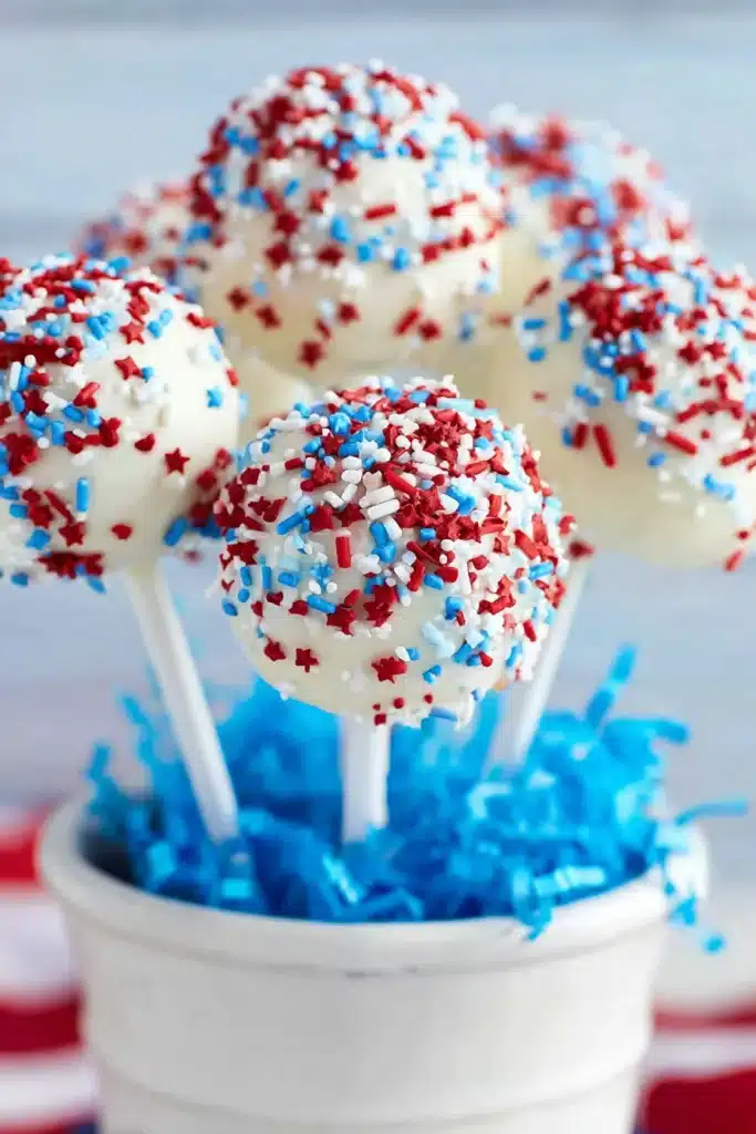 4th of July cake pops with white chocolate coating and red white blue sprinkles