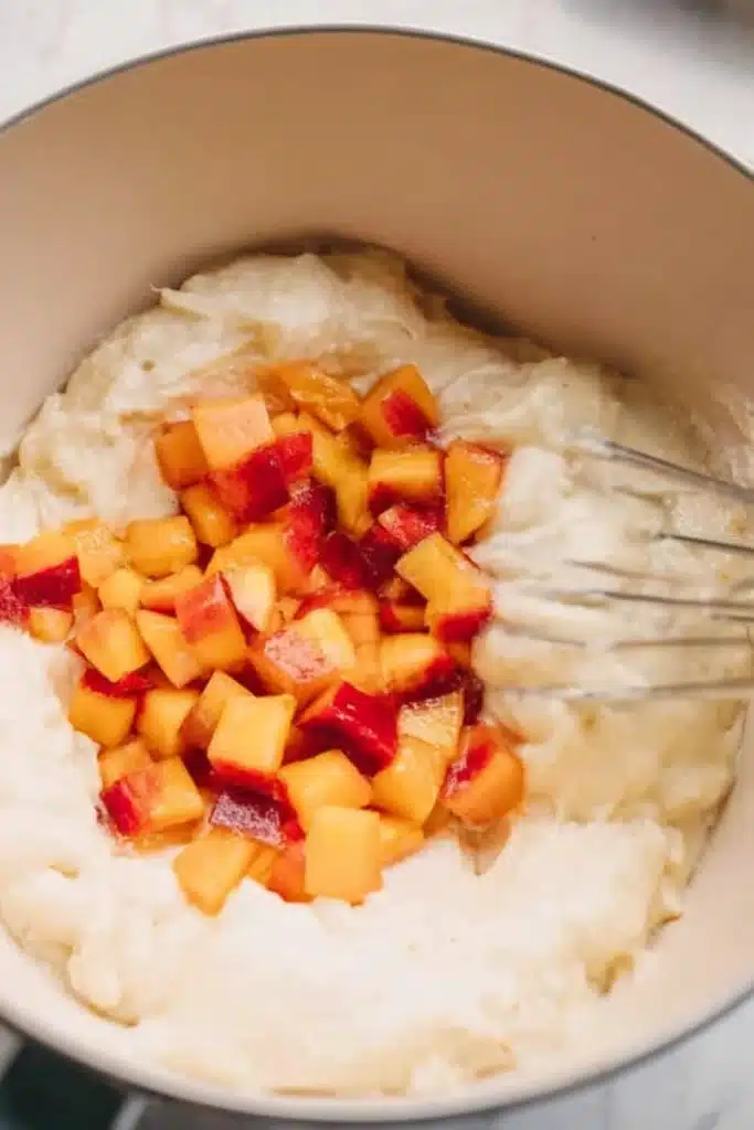 Peach upside down mini cakes batter with diced peaches being mixed