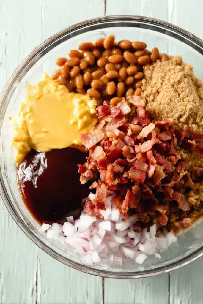 BBQ Baked Beans ingredients in a glass bowl before mixing