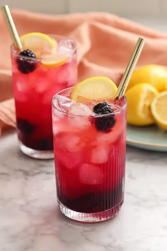 Blackberry Lemonade 1 Blackberry Lemonade with fresh lemon slices, blackberries, and ice in tall glasses