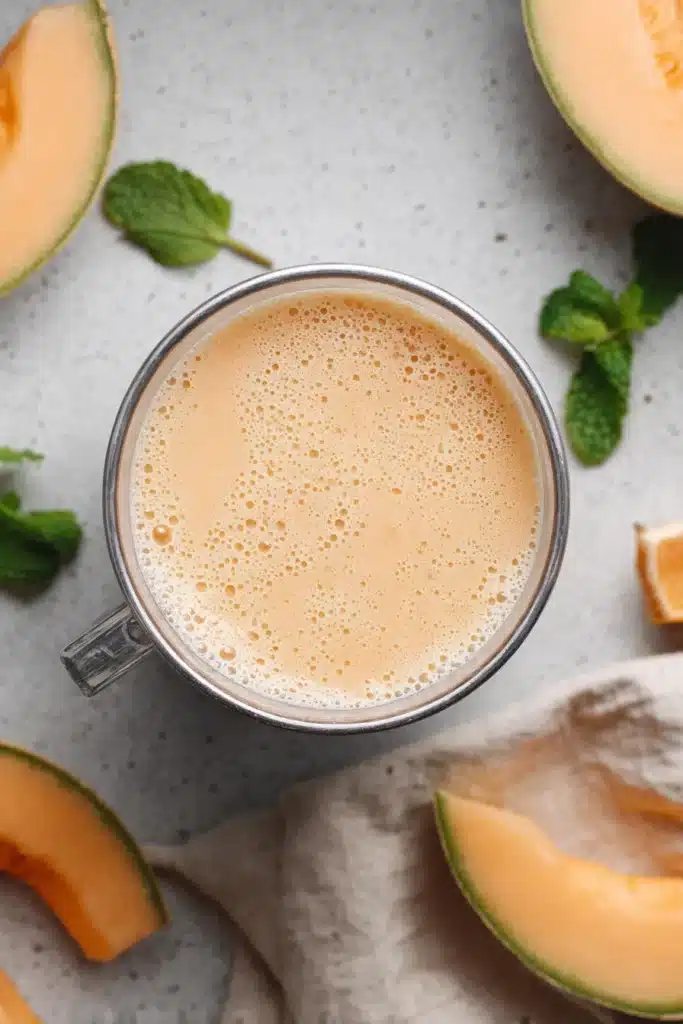 Cantaloupe Smoothie Recipe 3 Blended cantaloupe smoothie in a blender cup ready to serve