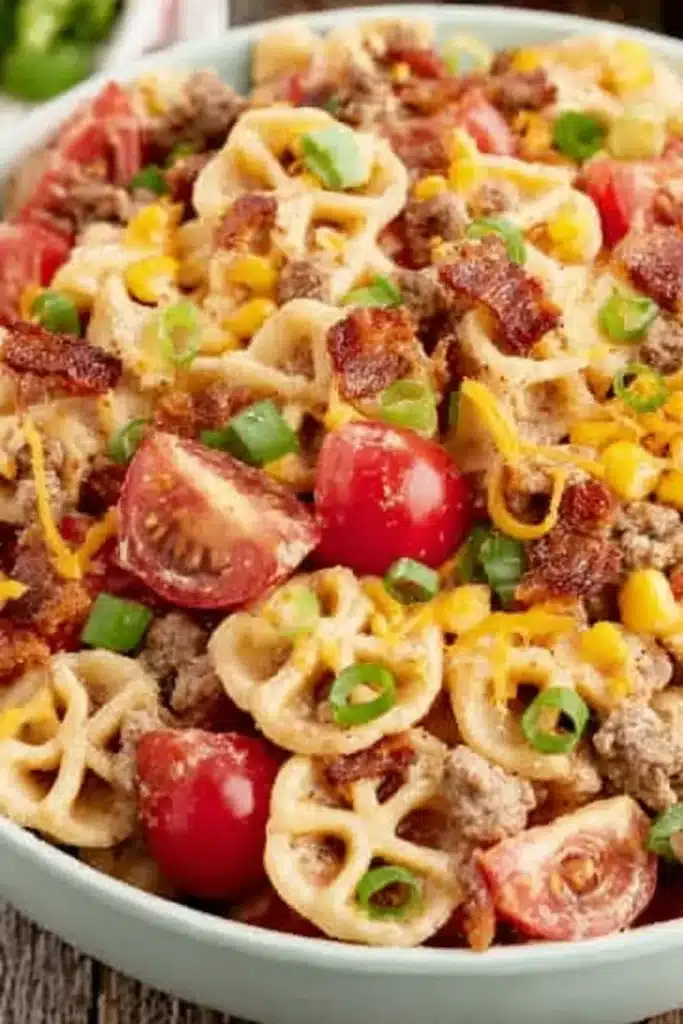 Cowboy Pasta Salad with bacon, beef, corn, cheddar cheese, and creamy barbecue dressing