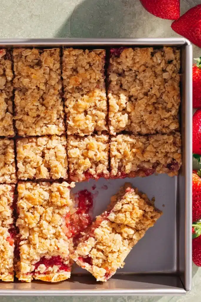 Healthy Strawberry Oatmeal Bars 5 Healthy Strawberry Oatmeal Bars sliced in a pan with golden oat topping