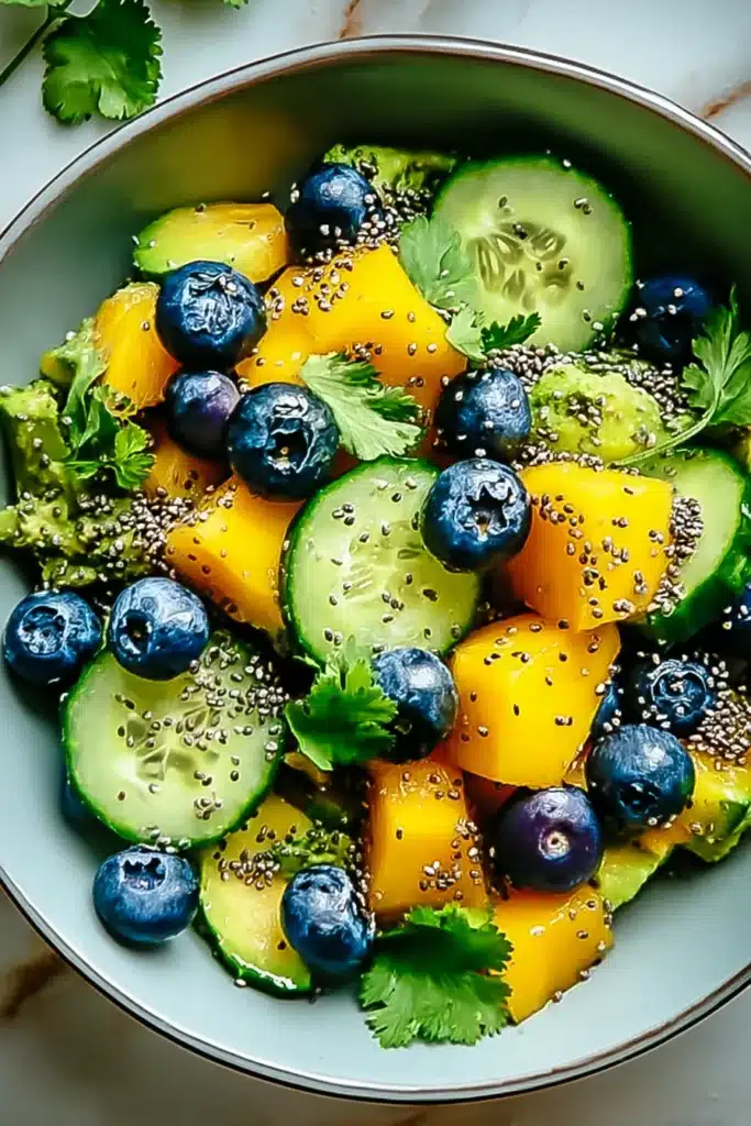 Juicy Mango Cucumber Salad 1 Juicy Mango Cucumber Salad with blueberries, avocado, and fresh herbs