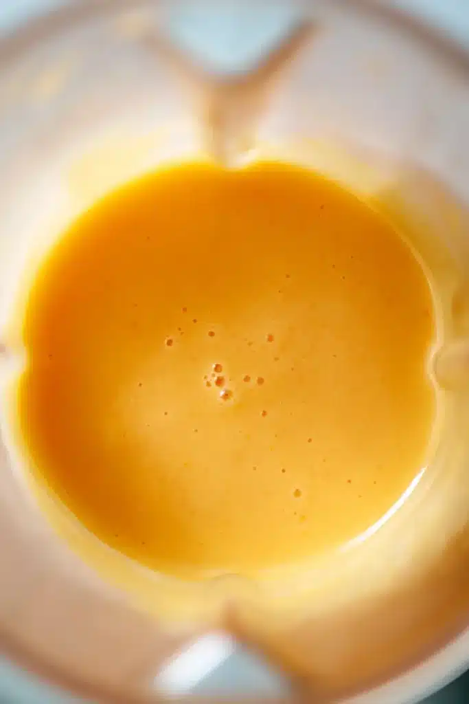 Smooth Peach Sorbet puree blended until creamy in a blender
