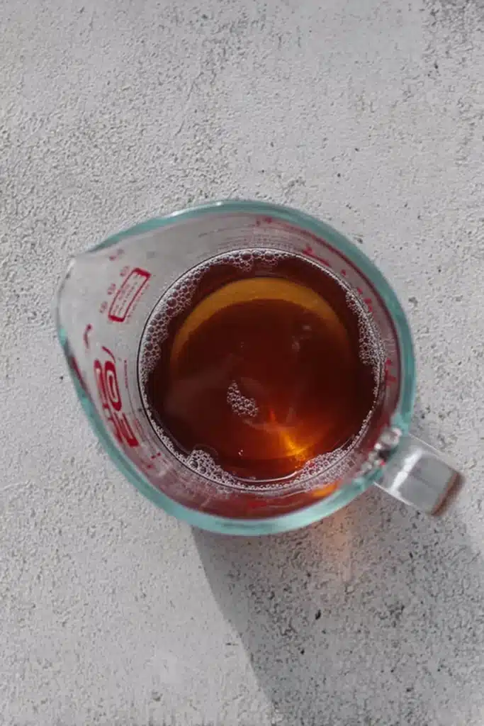 Refreshing Apple Iced Tea 3 Refreshing Apple Iced Tea cooling in a glass measuring cup before serving
