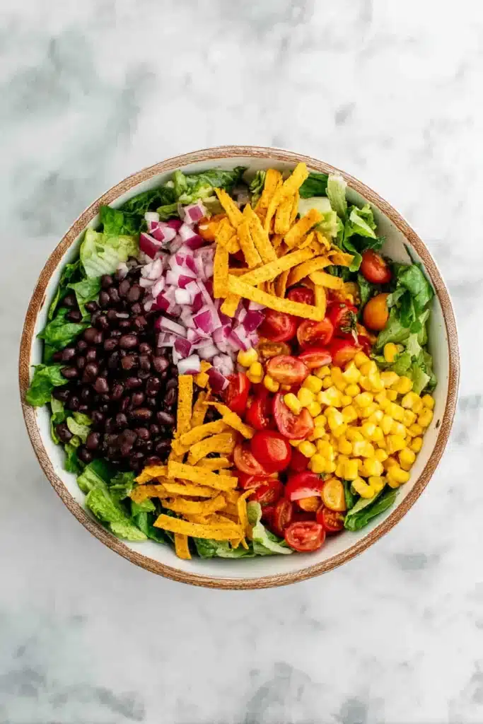 Southwest Salad Recipe 4 Southwest Salad assembled with black beans, corn, tomatoes, and tortilla strips