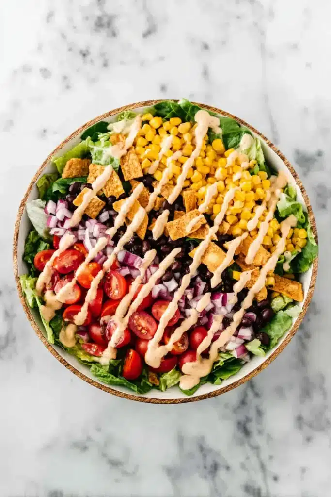 Southwest Salad Recipe 5 Southwest Salad with chipotle ranch dressing over black beans, corn, and vegetables