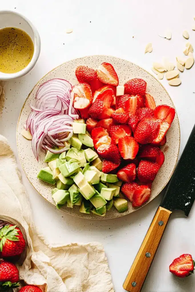 Prepared Strawberry Avocado Spinach Salad ingredients with sliced strawberries, avocado, and red onion